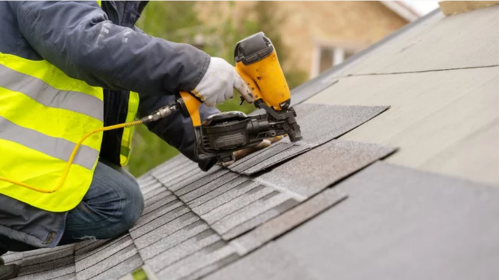 Contractor performing precision roofing repair on asphalt shingles