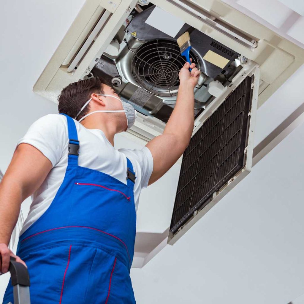 HVAC professional installing an indoor climate control system